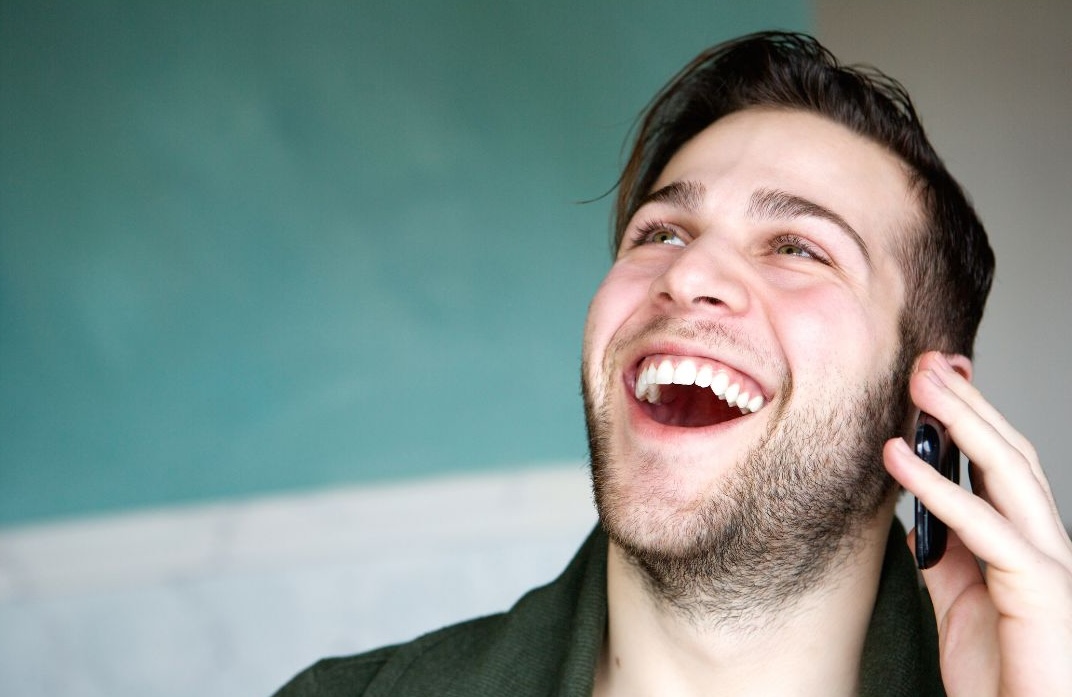 man having playful conversation on phone